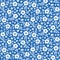 Seamless ditsy floral pattern in vector. Small white flowers on a blue background