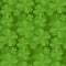 Seamless floral texture with a happy four-leaf clover.
