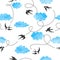 Seamless flying swallows and blue watercolor clouds pattern