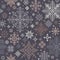 Seamless knitted pattern with gray, beige and white snowflakes