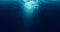 Seamless loop of deep blue ocean waves from underwater background, light rays shining