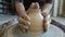 Seamless loop of hand-made ceramic pot spinning on potter`s wheel in craftsman`s hands