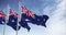 Seamless loop in slow motion of three Australia flags waving on a clear day