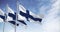 Seamless loop in slow motion of three Finland national flags waving