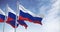 Seamless loop in slow motion of three Russia flags waving on a clear day