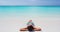 SEAMLESS LOOP VIDEO: Beach travel woman sunbathing relaxing lying down at beach
