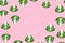 Seamless minimalistic pattern with broccoli on a pink background