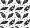 Seamless monochrome pattern with petals and folk decoration. Texture with black leaves with tribal ornament and dots on white