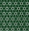 Seamless ornate pattern with abstarct silver flowers or snowflakes on dark grren background in vector. Print for fabric, wrapping