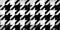 Seamless painted houndstooth black and white artistic acrylic paint texture background