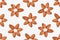 Seamless pattern of almonds arranged in flowers shapes.