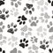 Seamless pattern with animal paw prints. Complex illustration print in black and white.