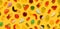 Seamless pattern of assorted jelly gum fruit candy on yellow background