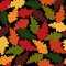 Seamless pattern. Autumn. Multicolored fallen oak leaves on a black background. Flat style.