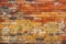 Seamless pattern background with an old and weathered yellow and red brick wall.