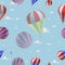 Seamless pattern of balloons against the blue sky with clouds