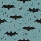 Seamless pattern with black bats on an emerald background
