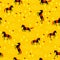 Seamless pattern of black horses on a gold field. Vector graphics