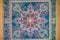 Seamless pattern on blue fabric background with white and orange elements. Classic Turkish textile ornament, mandala, kaleidoscope