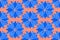 Seamless pattern, blue geometric stylized cornflower flowers, in a simple pattern on a coral background. Bright ornament