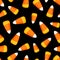 Seamless pattern with candy corn on a black background. Vector illustration.