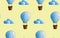 Seamless pattern with cartoon aerostat and clouds on a yellow background. Blue balloon. Creative kids texture for fabric, wrapping