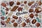 Seamless pattern with chocolates, chunks of chocolate, candies in colored wrappers on blue background
