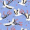 Seamless pattern with cranes birds and sakura. Vector graphics