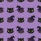Seamless pattern with cute Halloween kittens on purple background.