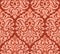 Seamless pattern with Damask motifs in red tones