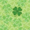 Seamless pattern with dotted four leaf clover in white on the green background. Traditional symbol of St. Patrick Day.