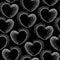 Seamless pattern with dotted hearts on a black background