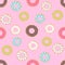 Seamless pattern of doughnuts with colored icing. Trendy beautiful donuts Pink background