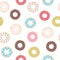Seamless pattern of doughnuts with colored icing. Trendy beautiful donuts White background