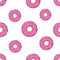 Seamless pattern with falling big and small donuts with pink glaze and colored sugar dragees