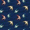 Seamless pattern with flying colorful swallows