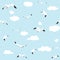 Seamless pattern flying seagull with clouds on blue background