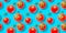 Seamless pattern of fresh ripe red cherry tomatoes isolated on blue background