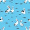 Seamless pattern. Groups of pelican birds and fish flocks on a blue background.