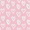 Seamless pattern from grunge handmade white hearts on a pink