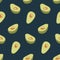 Seamless pattern of half avocado on dark green background.