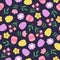 Seamless pattern with hand drawn Easter eggs, flowers and leaves. Cutout colorful plants and eggs on dark blue