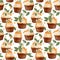 Seamless pattern of illustrated cupcakes with cream and sea buckthorn berries and green leaves on a white background