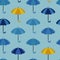 Seamless pattern with open umbrellas. Rows of umbrellas in shades of blue and sometimes yellow. Vector illustration, flat cartoon