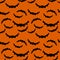 Seamless pattern orange background with black endless bat on halloween.