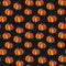 Seamless pattern of orange pumpkins on a black background. Illustration for Halloween. Fall, thanksgiving concept