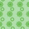 Seamless pattern of ornate mandalas in green on a light green background, ornate curls in vertical rows for design