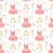 Seamless pattern of pink ballerina tutu dresses on mannequins, hair bands, stars, and magic wands