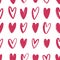 Seamless pattern with pink hand drawn hearts on white background. Backdrop with love, passion and dating symbols