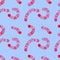 A seamless pattern of pink red caterpillars on a blue background.